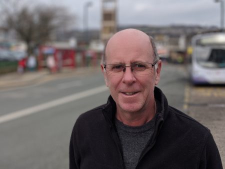 Green Party Councillor Martin Love standing in Shipley Market Place