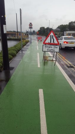 Road works sign placed in segregated cycle lane Stanley Road in Bradford BD2