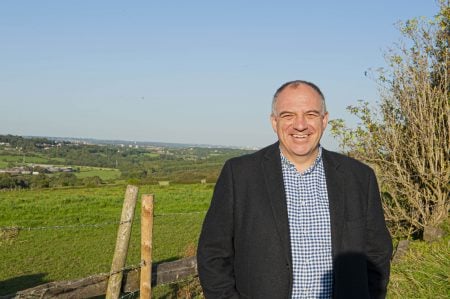 Andrew Cooper standing in a field overlooking the Tong Valley