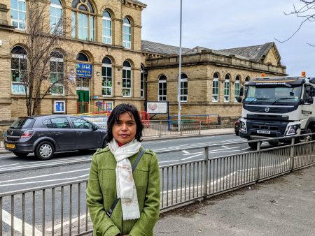 Haearun Hussain standing outside Wycliffe School with traffic on Saltaire Road
