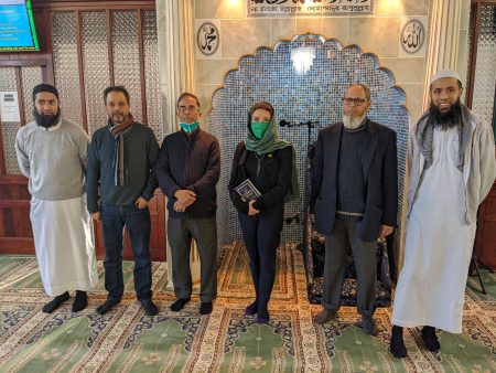 Carla Denyer standing with imans and community leaders inside Shipley Islamic Centre ... an old church converted into a mosque.