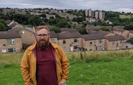 Councillor Matt Edwards stood on a bank overlooking Holmewood, a former council housing estate made up of 70s style houses and two tower blocks.
