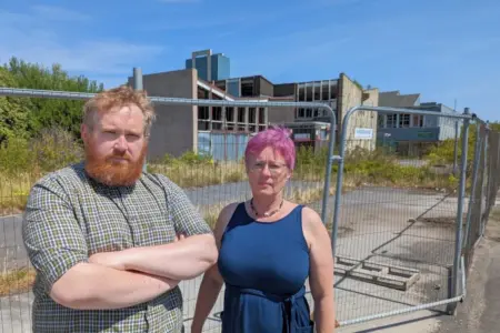 Matt Edwards and Celia Hickson in front of the former Yorkshire Martyrs building which has significant fire damage